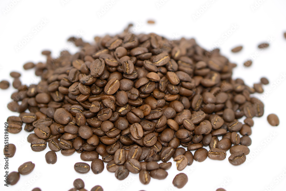 Fototapeta premium some roasted coffee beans placing on a white paper