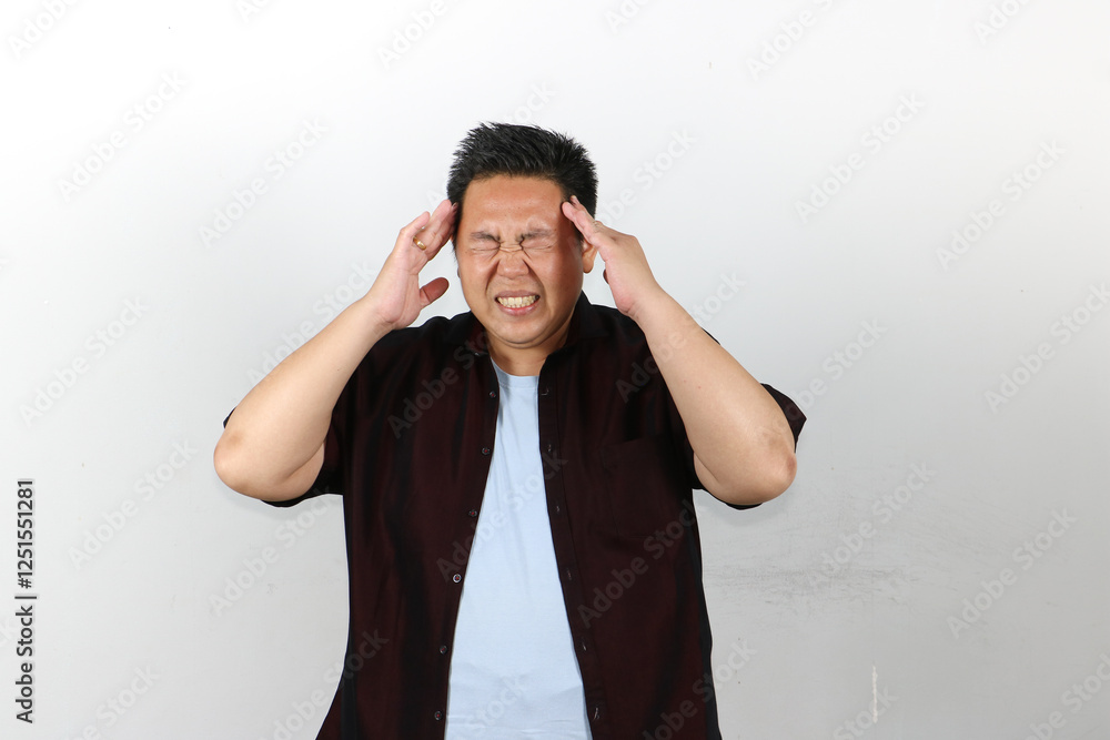 Man Suffering from very bad Headache, both hands on his head Man Suffering from very bad Headache, both hands on his head