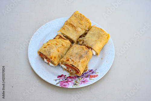 Freshly baked appetizing Turkish tortillas - Gozleme with spinach, cheese  on a white board. Space for text. Handmade Turkish traditional pastries. Ispanakli, otlu peynirli gozleme. Tahinli Katmer photo