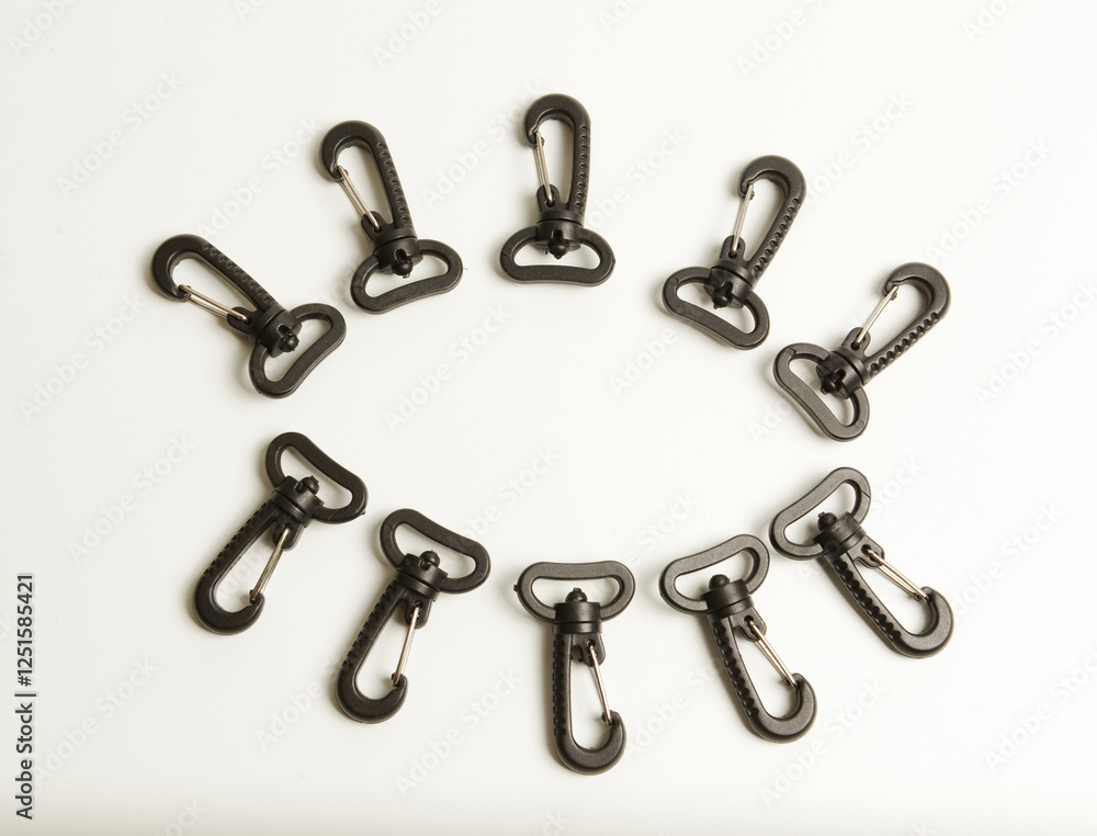 Black plastic and metal swivel hooks, isolated on white. Black plastic and metal swivel hooks, isolated on white.