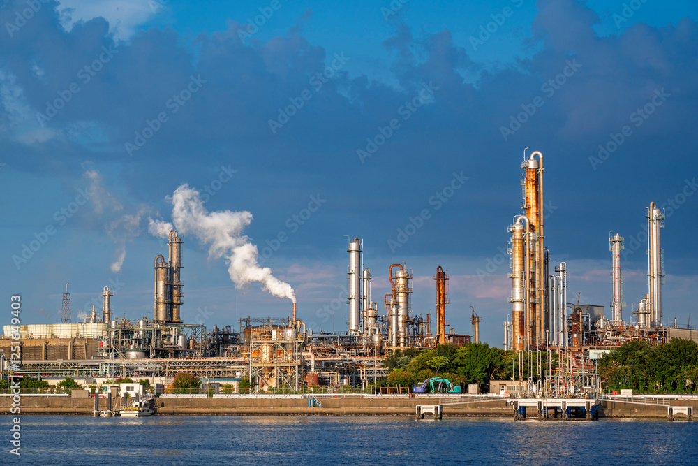 equipment of gas oil refining plant in Japan industrial factory area with blue sky background view from Fishing port, Yokkaichi, Mie Prefecture, Japan.