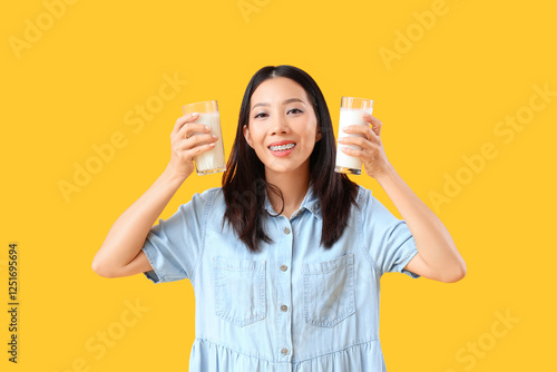 Young Asian woman with glas...