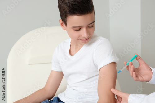 Little boy receiving vaccin...
