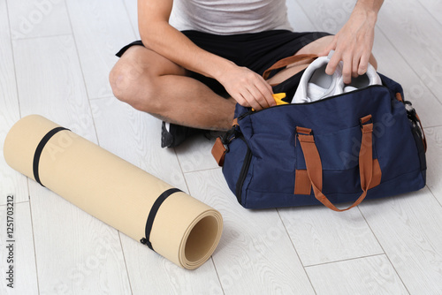 Young man with sports bag a...