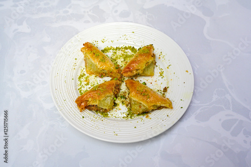 Turkish Dessert Sobiyet, havuc dilimi, midye baklava, mussels baklava and classic baklava with Pistachio . Cikoltali cevizli, fistikli soguk Baklava, top view. photo