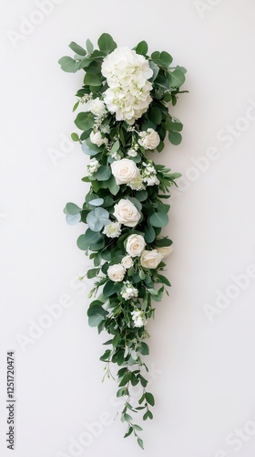 Elegant floral arrangement with greenery and white roses for wedding decor