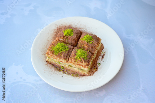 Turkish Dessert Sobiyet, havuc dilimi, midye baklava, mussels baklava and classic baklava with Pistachio . Cikoltali cevizli, fistikli soguk Baklava, top view. photo