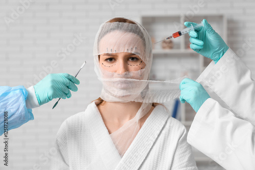 Young woman with bandaged h...