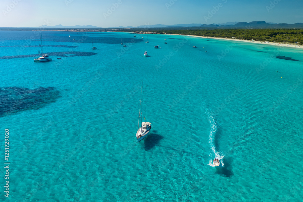 Beautiful sailboats is moored in the incredible turquoise waters of Mallorca
