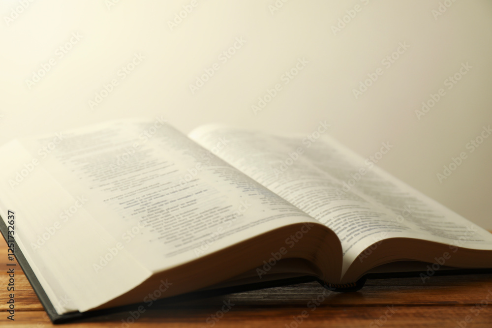 Open Holy Bible in English language on wooden table, closeup Open Holy Bible in English language on wooden table, closeup