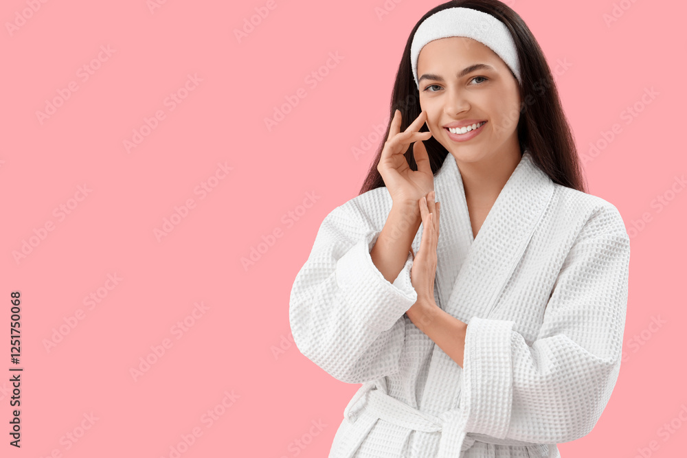 Beautiful young happy woman in bathrobe on pink background Beautiful young happy woman in bathrobe on pink background