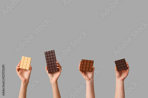 Four hands holding differen...