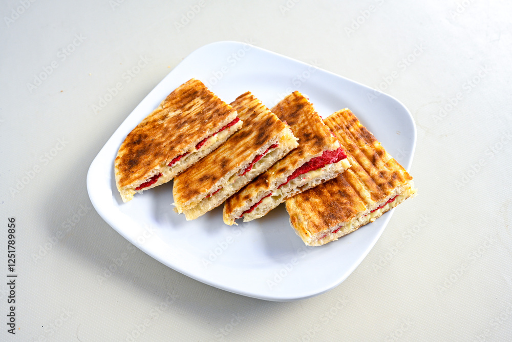Turkish karisik atom Ayvalik tost ( kasarli bazlama tost) . Sucuklu, Kasarli, kavurmali karisik tost. Flat baked bread toasted. Karisik bazlama tost . Turkish karisik atom Ayvalik tost ( kasarli bazlama tost) . Sucuklu, Kasarli, kavurmali karisik tost. Flat baked bread toasted. Karisik bazlama tost .