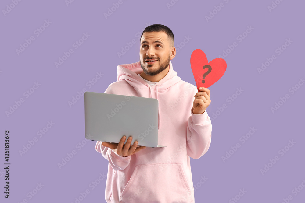 Young man with heart and laptop on lilac background. Online dating Young man with heart and laptop on lilac background. Online dating