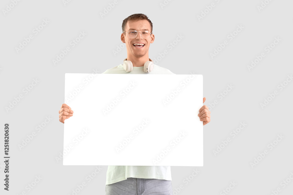 Man with blank poster on grey background Man with blank poster on grey background