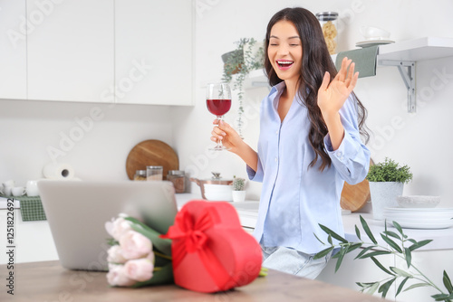 Young woman drinking wine a...
