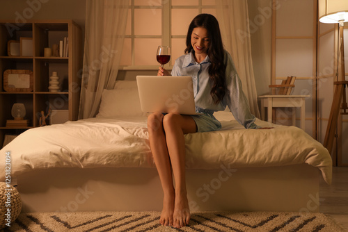 Young woman drinking wine a...