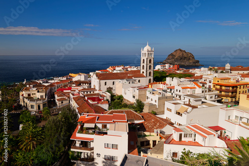 Panorama of Garachico town in Tenerife on a sunny winter day. Garachico rock island. Church with tall bell tower. Calm sunny day in the winter at Christmas time.