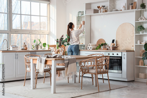 Young woman near shelf unit...