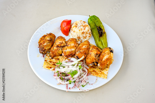 Chicken wings barbeque in a dish with BBQ grill sauce . Izgara tavuk kelebek sis kanat. Izgara tavuk sis, gogus. photo