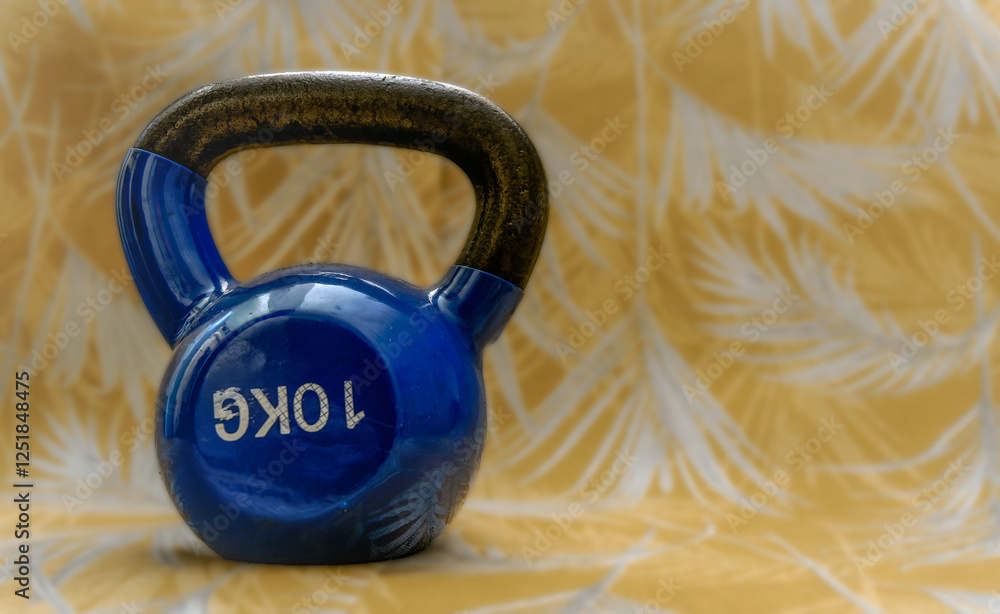 Blue kettlebell resting on patterned background