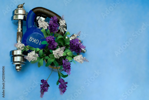 Obraz na płótnie Fitness and wellness concept with kettlebell and flowers w salonie