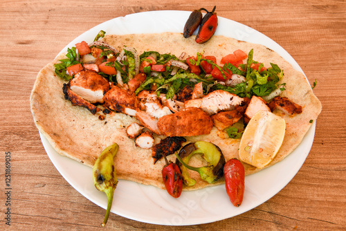 Lavash zurna doner kebab ( zurna  durum )  or shawarma sliced in plate isolated.  hatay usulu tavuk Et doner durum. Gobit ekmek arasi doner. Pilavustu iskender doner kebap.  photo