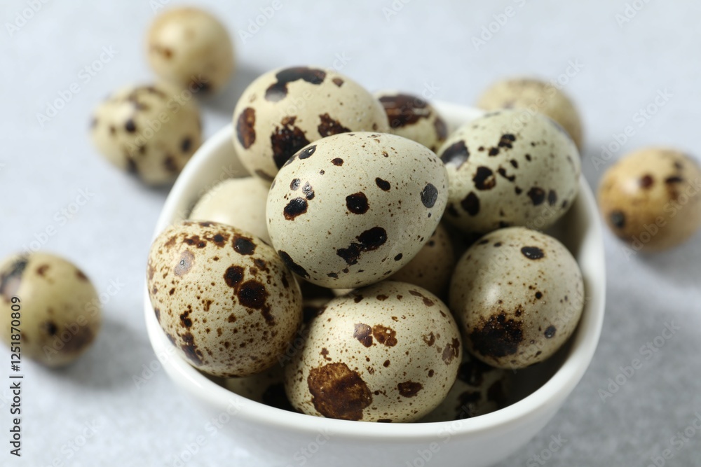 Quail eggs in a plate on gray background Quail eggs in a plate on gray background
