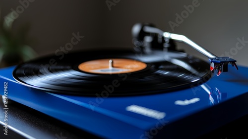 Blue turntable playing vinyl record, home music setup
