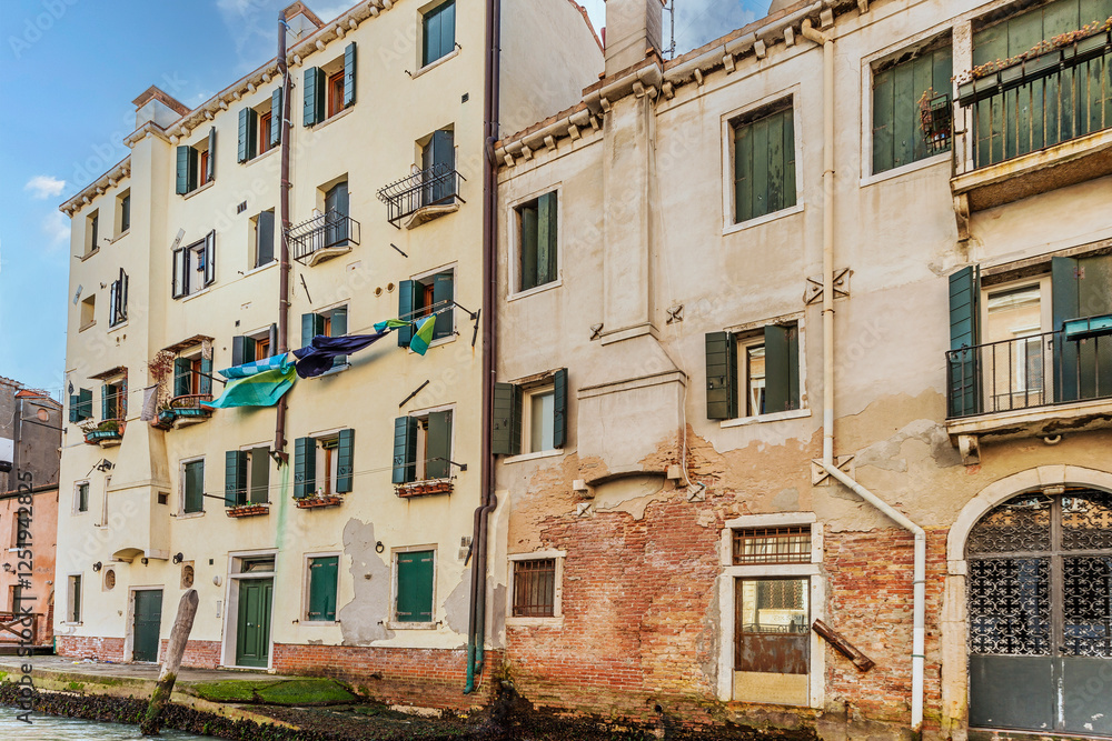 Facade of Old buildings in inland canals which are the waterways of Venice, Italy, 2019 Facade of Old buildings in inland canals which are the waterways of Venice, Italy, 2019