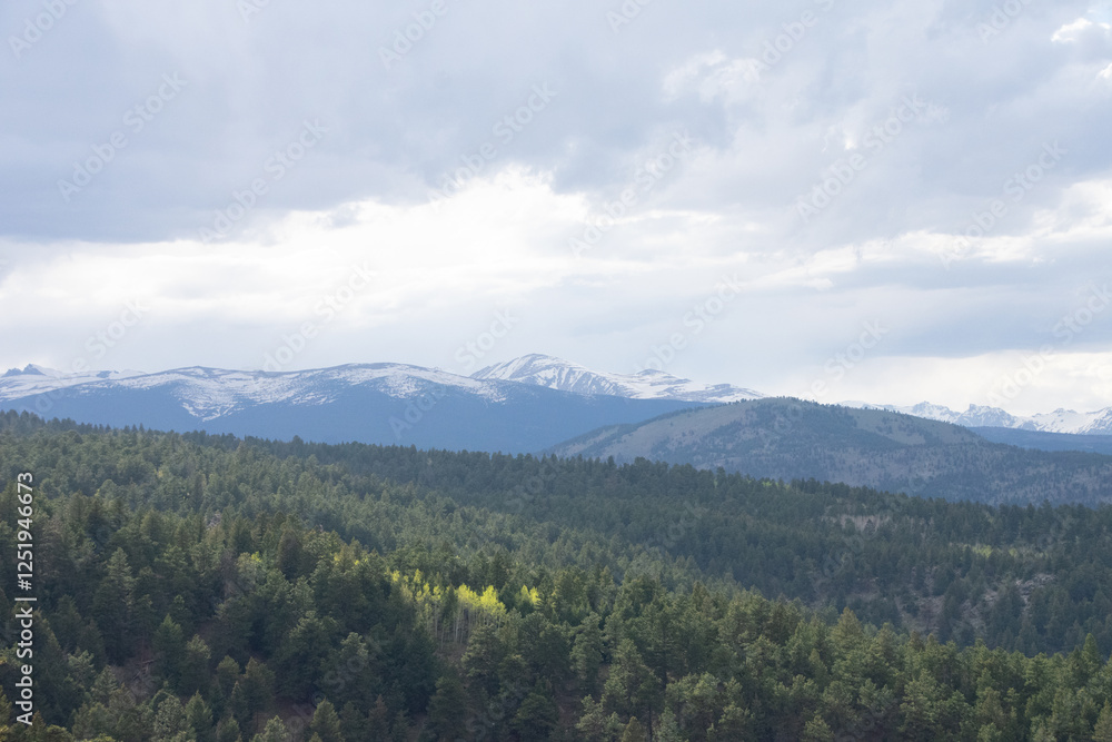 Fototapeta premium Clouds coming in over the rocky mountains