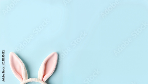 Bunny ears against light blue wall, Easter celebration theme photo