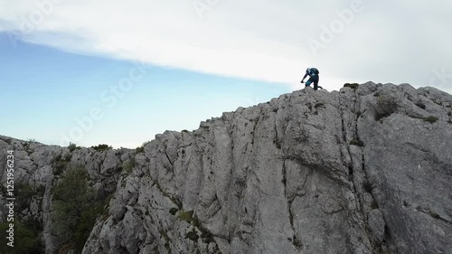 a man traversing a rocky terrain in Sainte Baume, France