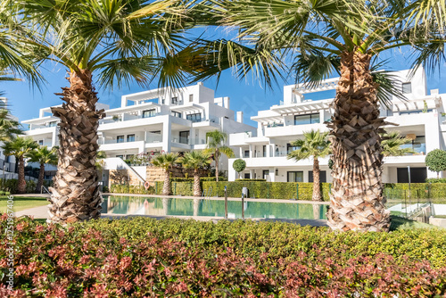 an image of luxury mediterranean holiday homes surrounded with palm trees and swimming pool