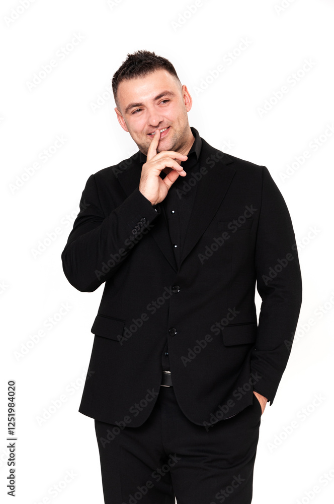 A handsome dark-haired man wearing a business suit, a black shirt on a white background A handsome dark-haired man wearing a business suit, a black shirt on a white background