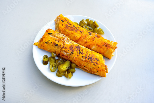 Lavash doner kebab ( soslu kasarli zurna doner durum )  or shawarma sliced in plate isolated.  Tavuk Et Doner Durum. Hatay Iskenderun usulu bazuka tavuk doner durum.  photo