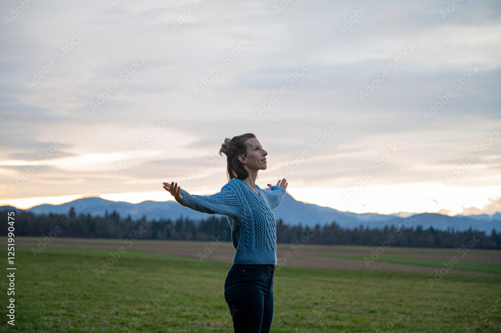 Woman embracing the sunset in nature Woman embracing the sunset in nature