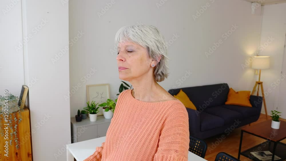 Happy senior adult woman holding a glass of water in the morning at home. Healthy life habit, lifestyle concept Happy senior adult woman holding a glass of water in the morning at home. Healthy life habit, lifestyle concept