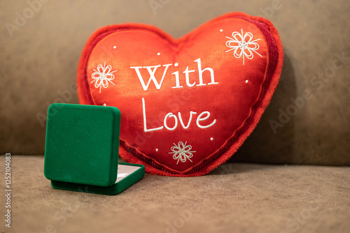 A heart-shaped pillow with the inscription 