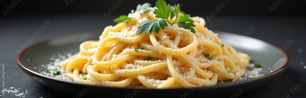 Italian pasta dish with creamy Alfredo sauce and Parmesan cheese, garnished with fresh parsley on grey plate. Delicious spaghetti on wooden table. Gourmet food background. Italian pasta dish with creamy Alfredo sauce and Parmesan cheese, garnished with fresh parsley on grey plate. Delicious spaghetti on wooden table. Gourmet food background.
