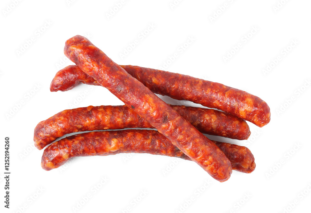 Many thin dry cured sausages isolated on white, top view Many thin dry cured sausages isolated on white, top view