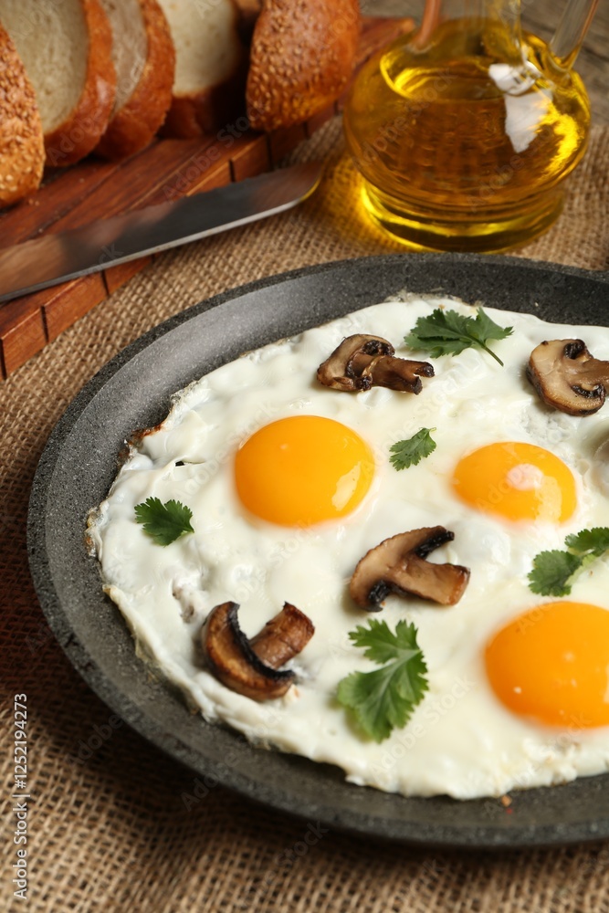 Tasty fried eggs with mushrooms and parsley served on table, closeup Tasty fried eggs with mushrooms and parsley served on table, closeup