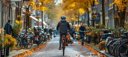Cyclist in Autumn, Amsterdam. Cycling through the colorful streets of Amsterdam in fall.