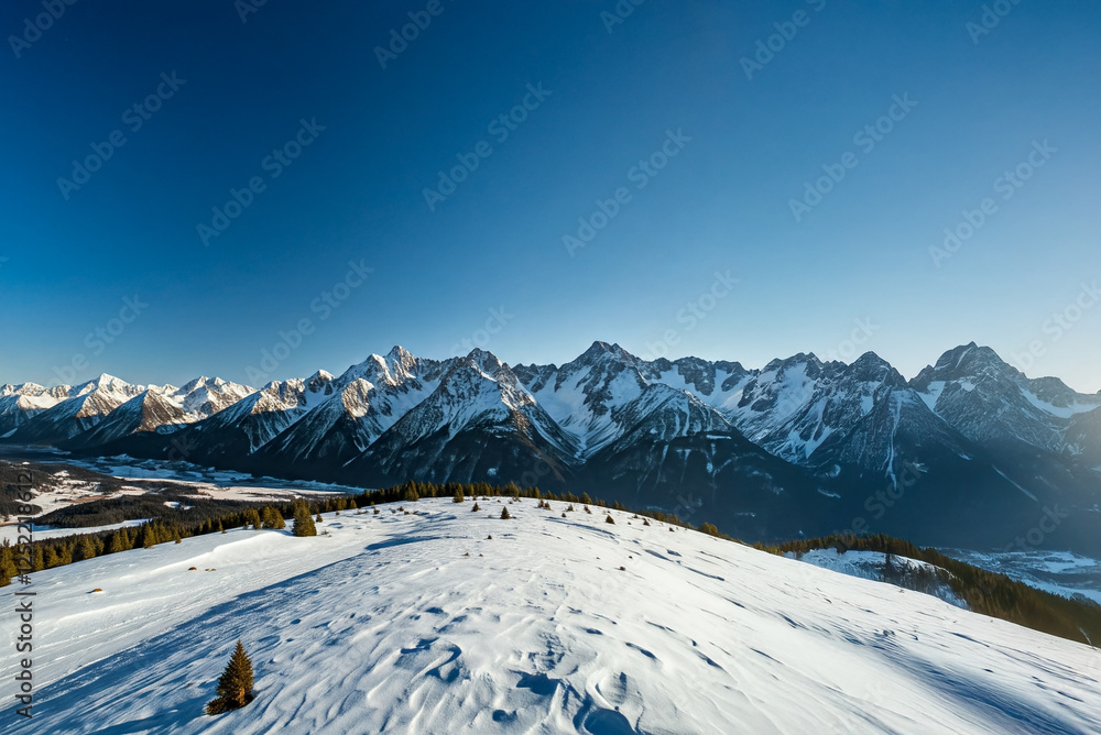 Obraz premium Majestic white spruces glowing by sunlight. Picturesque and gorgeous wintry scene. ski resort. Blue toning. Happy New Year! Beauty world.