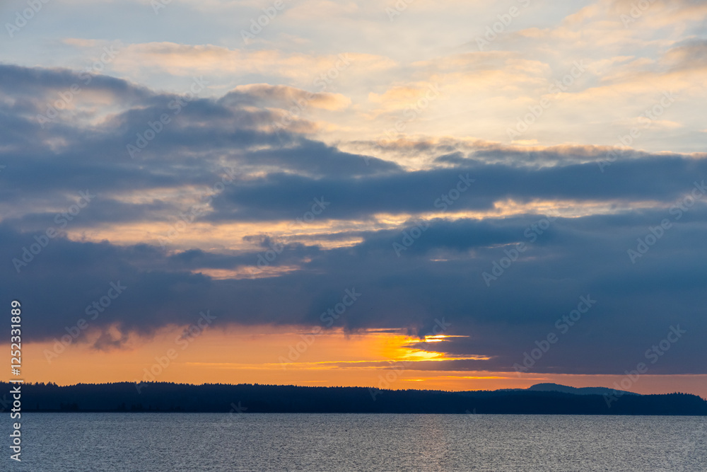 Serene Sunset Over Calm Waters and Foreboding Clouds in Vibrant Skies Serene Sunset Over Calm Waters and Foreboding Clouds in Vibrant Skies