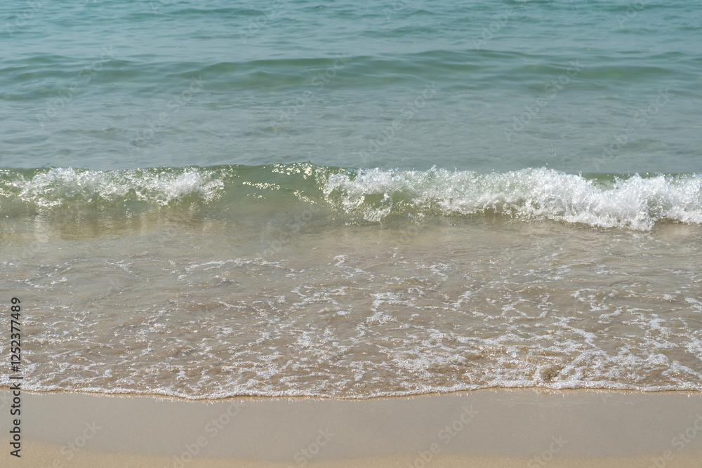 Summer waves crash on the sandy beach Summer waves crash on the sandy beach
