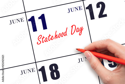 June 11. Hand writing text Statehood Day on calendar date. Save the date. photo