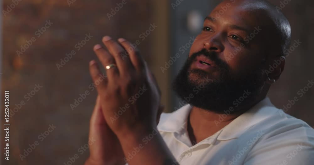 Man lifting hands and clapping in worship, African American man in white shirt with beaming expression during evangelical church service, spiritual joy and celebration