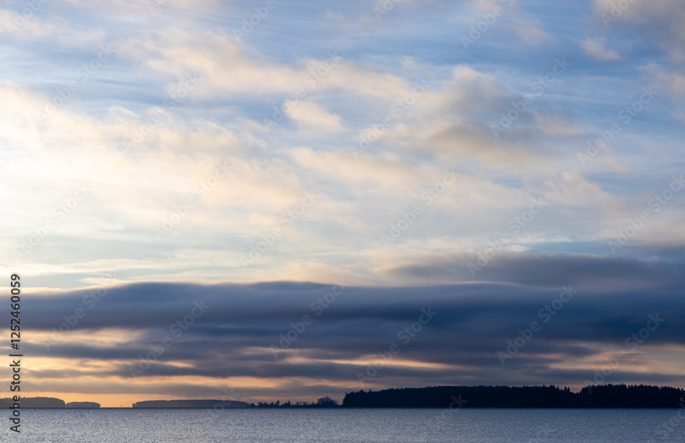 Scenic Morning Sky Over Calm Waters with Distant Horizons and Clouds Scenic Morning Sky Over Calm Waters with Distant Horizons and Clouds