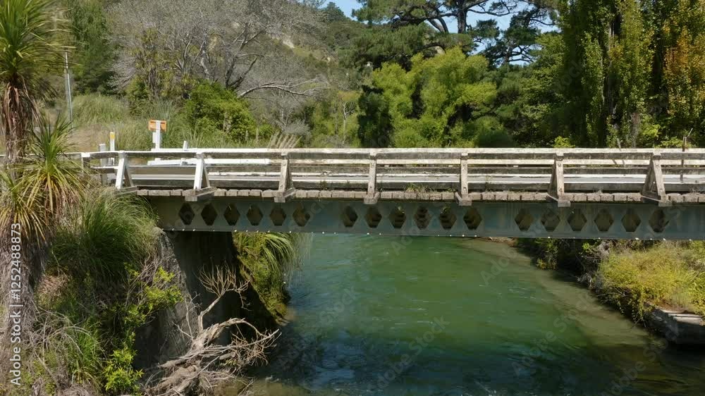Old concrete bridge over a flowing river. Nature's beauty and rustic charm. Waikaretaheke River, Wairoa, Hawkes Bay, New Zealand Old concrete bridge over a flowing river. Nature's beauty and rustic charm. Waikaretaheke River, Wairoa, Hawkes Bay, New Zealand